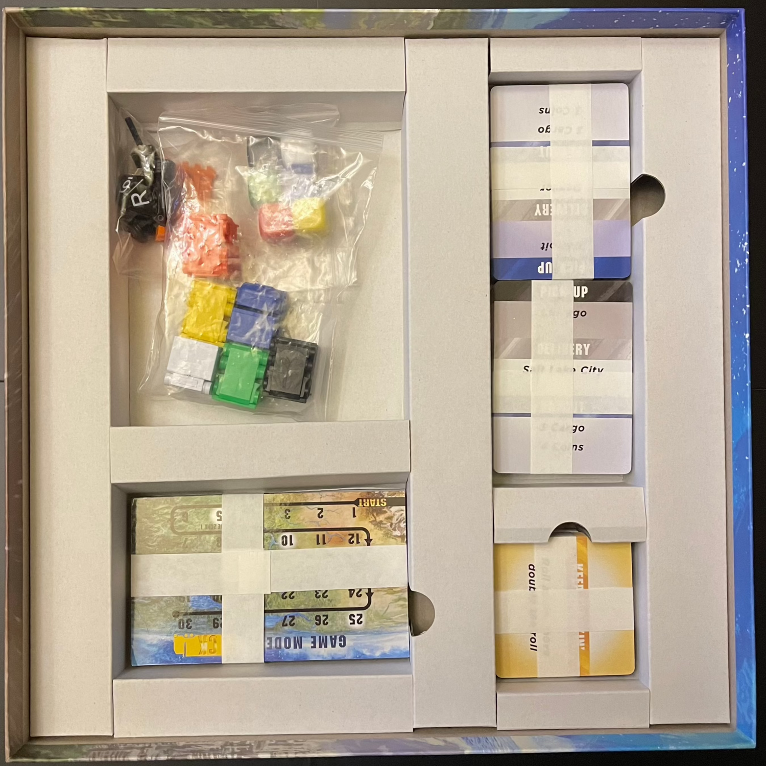 Inside of the Cargo Kings game box showing game pieces.